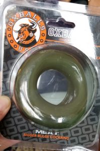 A large rubber cock ring in a plastic case from a company called Oxballs 