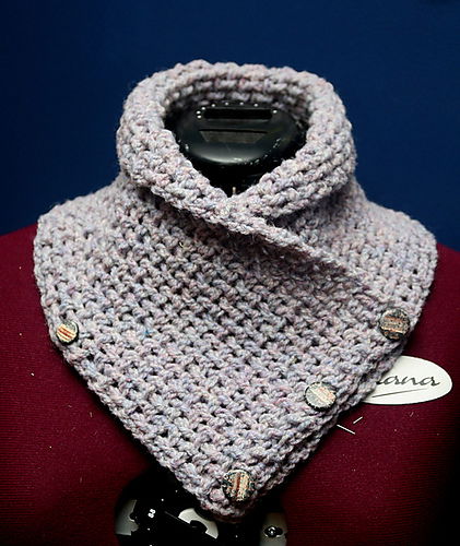 A gray cowl that buttons in the front.