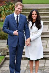 Harry and Meghan smiling so very very happily while posing with the ring showing