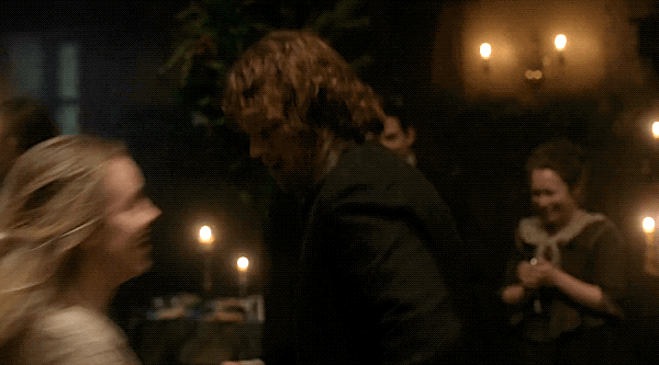 Jamie, Marsali, and Joan, dancing and smiling.