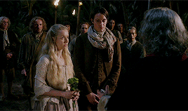 Fogden, Marsali, and Fergus all looking perplexed over Fergus' lack of surname, until Jamie says Fraser.