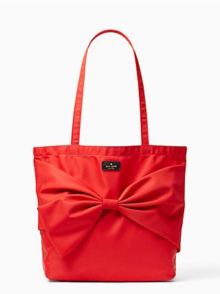 Red nylon tote with a bow on the front