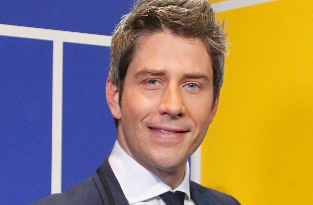 Arie looks at the camera and smiles, but in a way that suggets he smelled a really bad fart. And it's his.