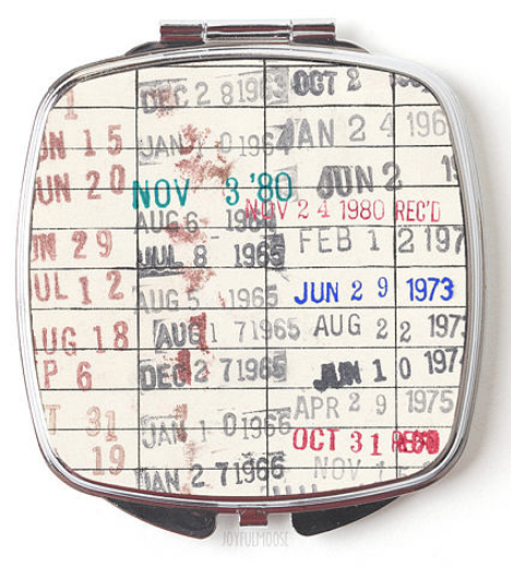 Library checkout card printed on a mirror compact