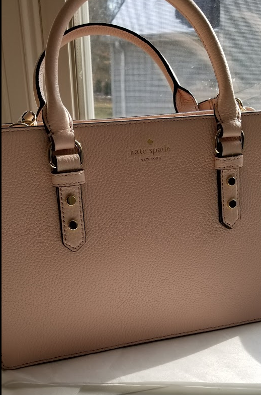 photograph of bag in low sunlight, showing handles and hardware 