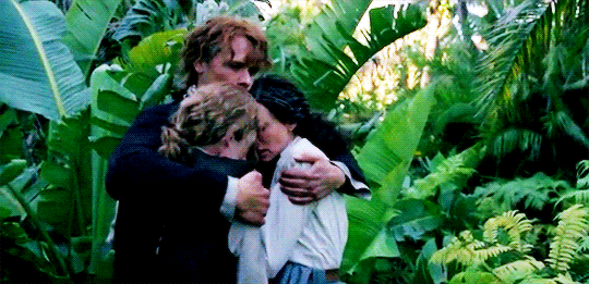 Jamie, holding Claire and Young Ian among a backdrop of green green jungle.