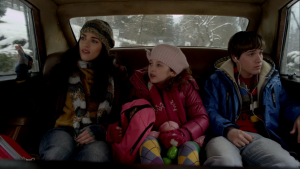 Jules and kids in the car driving up to the Hall