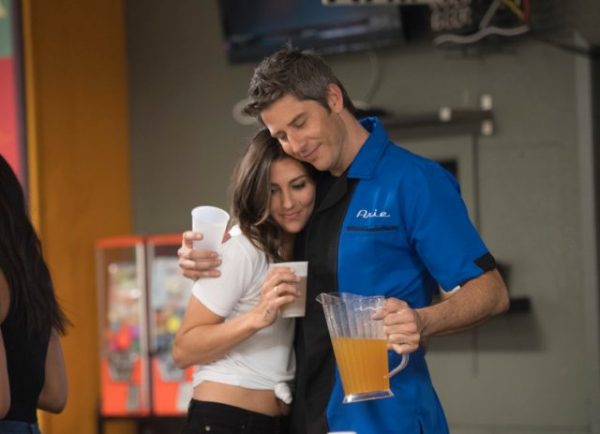 Arie and (I think) Tia hug and drink beer