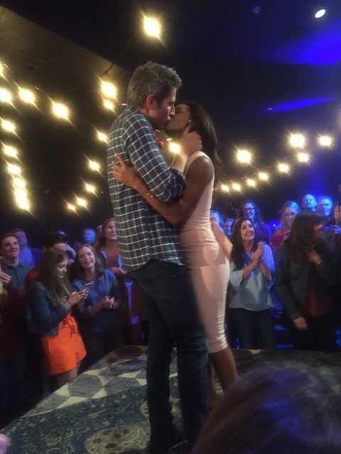 Arie and Seinne kiss in the middle of a concert crowd