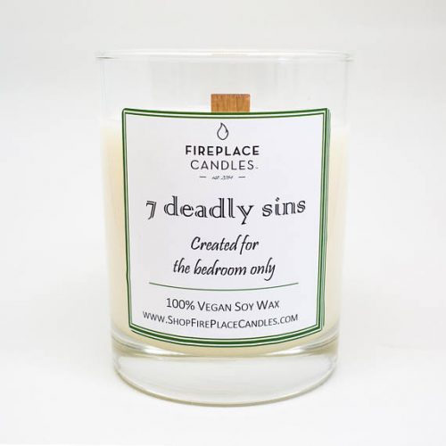 A white soy candle in a clear jar with the label of 7 deadly sins
