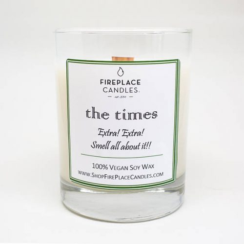 A white soy candle that smells like a newspaper. The label reads Extra Extra, smell all about it
