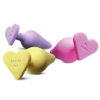 Naughty Candy Heart Butt Plug. Comes in three pastel colors. The purple one is stamped with do me now. The yellow one is stamped with spank me. The pink one is stamped with be mine.