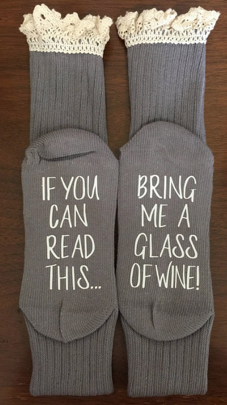 Grey lace topped socks that say on the bottom, if You Can Read This bring me a glass of wine