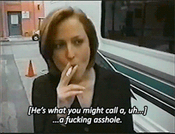 Gillian Anderson smokes a cigarette while dressed as Dana Scully and says he's what you might call a fucking asshole