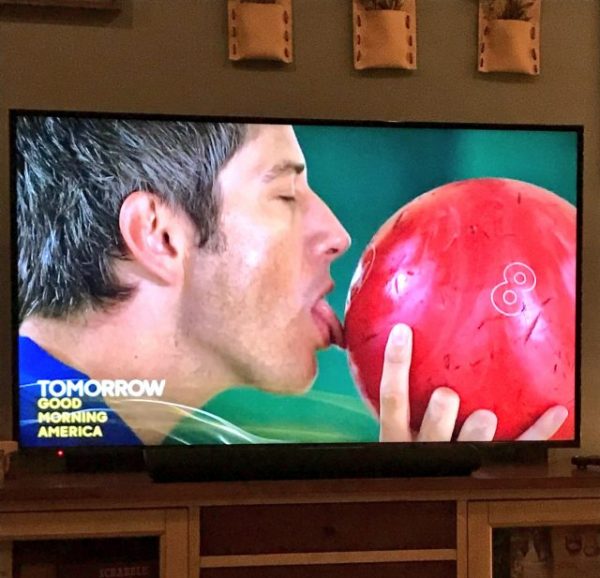 Arie licks a bowling ball