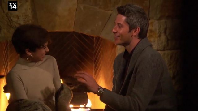 Arie and Bekah sit in front of the fire place.