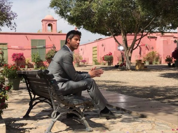 Arie sits on a bench and stares into the distance