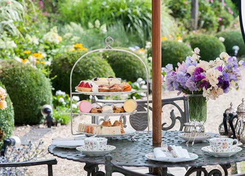 Afternoon tea items on a tray in the garden.