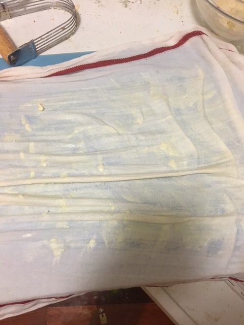 Tea towel that is wet and coated with butter.