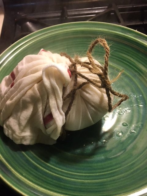 Wet towel wrapped pudding on a green stonewear plate