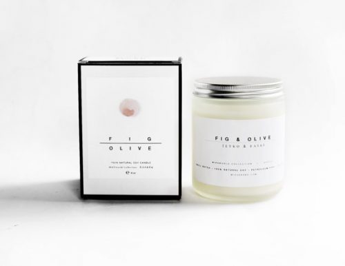 A white candle in a clear jar with a metal lid.