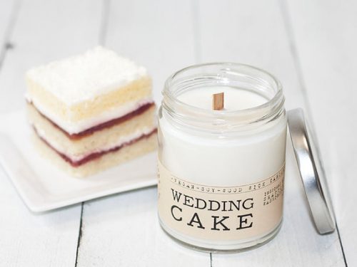 Whiskey Wicks Wedding Cake candle next to a slice of cake