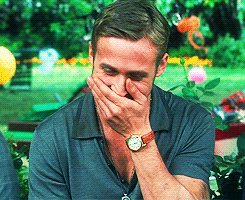 Ryan Gosling is laughing with his hand clamped over his mouth