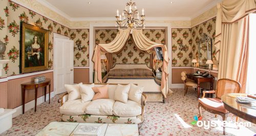 The Master Bedroom. Many flounces. With draperies and patterend wallpaper a massive chandelier and bed hangings to match the drapes and literally a dozen pillows