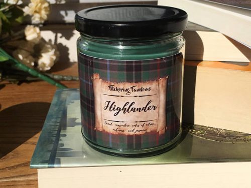 Flickering Fandoms Highlander scented candle. A green soy scented candle in a jar with a green and red plaid label.