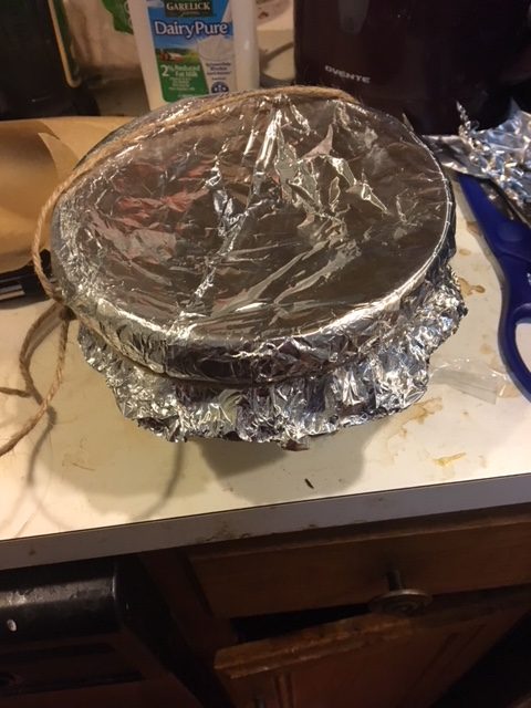 The pudding basic covered in foil and trussed up kinda like a goose.