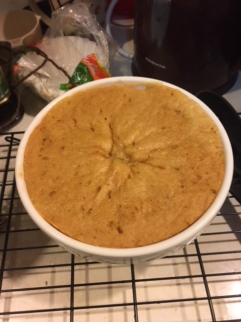 Finished sponge still in the basin, risen all the way to the top of the bowl.