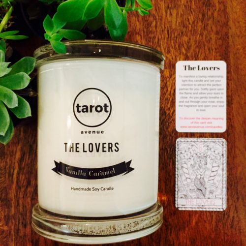 Tarot Avenue The Lovers Candle. A white candle in a clear jar positioned next to The Lovers tarot card.