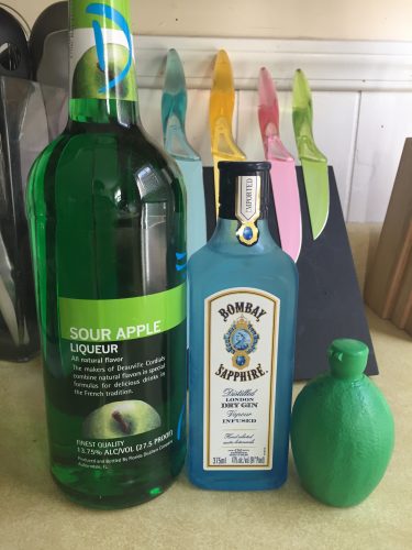 Ingredients for The Pleasure Garden drink sour apple liqueur sapphire gin and a lime juice