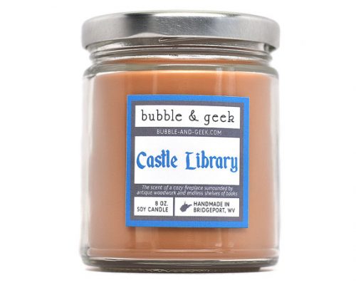 Bubble and Geek Candles in Castle Library scent. An orange brownish candle in a glass jar.