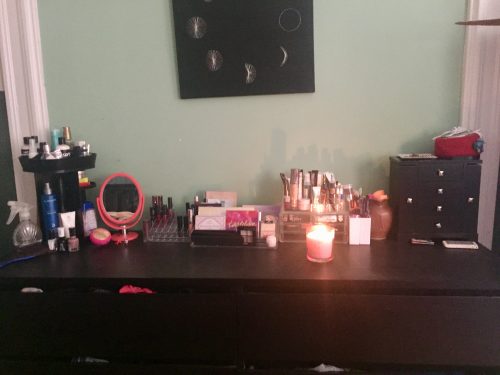 Amanda's current dresser layout. A black dresser with several clear organizers filled with makeup.