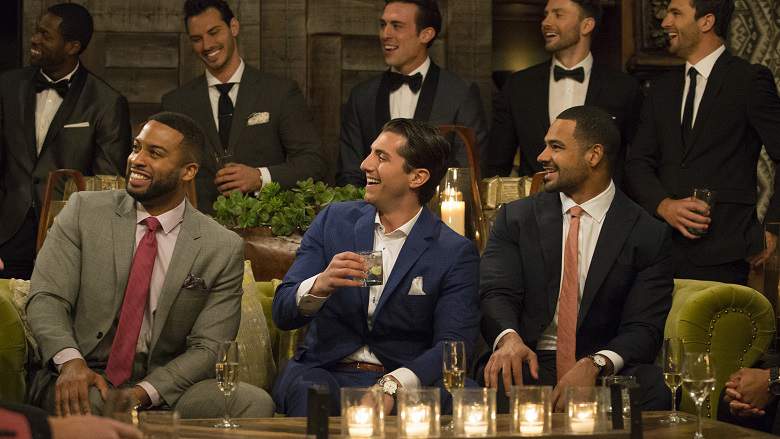 A bunch of the dudes sit on a drinking couch