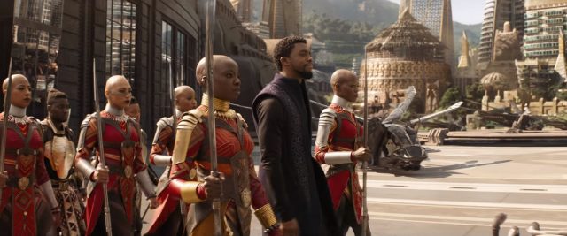 Okoye and T'Challa walk beside each other.