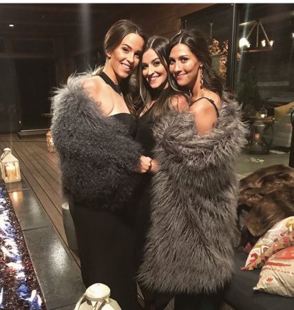 Becca, Tia and another woman hug each other. They are wrapped up in suuuper fuzzy throws and look comfy af
