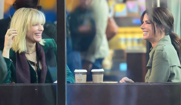Sandra Bullock and Cate Blanchett during the filming of Ocean's 8 laughing in a cafe