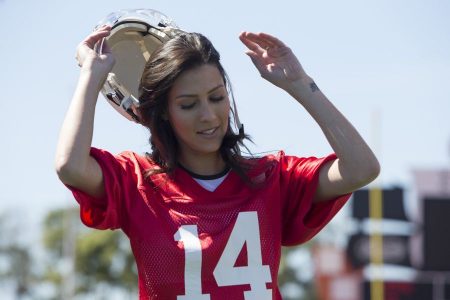 Becca wears a football jersey