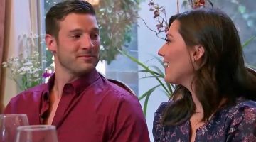 Garrett sits next to Becca. His shirt is mostly unbuttoned.