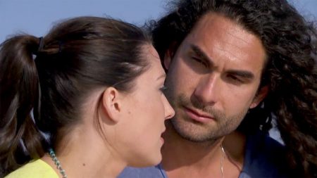 Becca and Leo talk on the beach