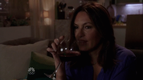 Olivia Benson from Law and Order drinks a glass of wine