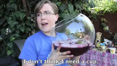 A woman holds a giant bottle of wine and says I don't think I need a glass