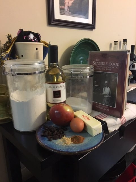 Ingredients! Flour, sugar, butter, apple, raisins, ginger, cinnamon, egg, and wine. Also Madame l'Odeur, a small stuffed skunk, lurking in the background.