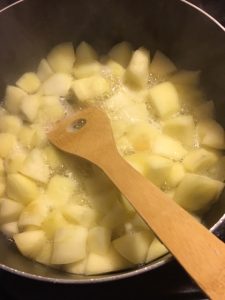 Boiling apples in wine.