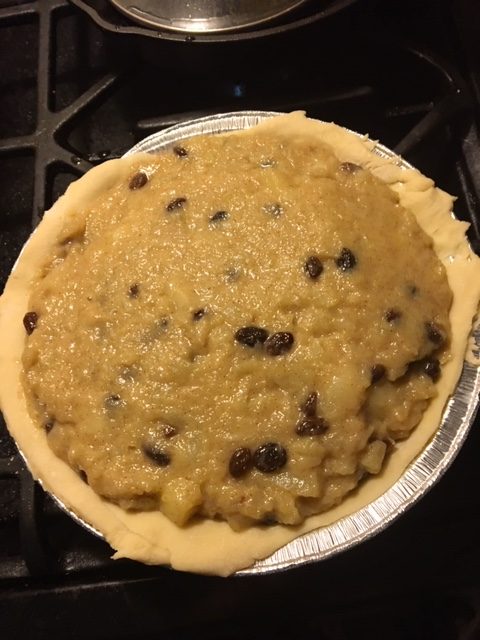 Filling in the pie pan.