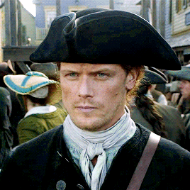 Jamie, wearing a tricorn hat, looking hot and stern.