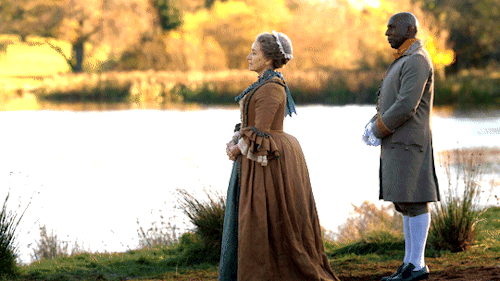 Jocasta, with Ulysses standing behind her, holding out her arms to welcome Jamie.