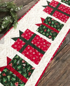 Primrose Cottages christmas present table runner quilted with quilted presents in green and red 